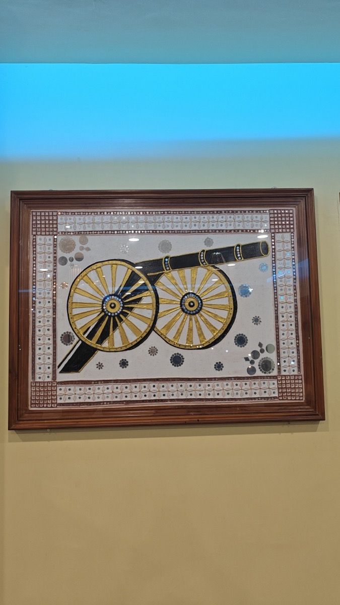 Framed cannon artwork on the wall